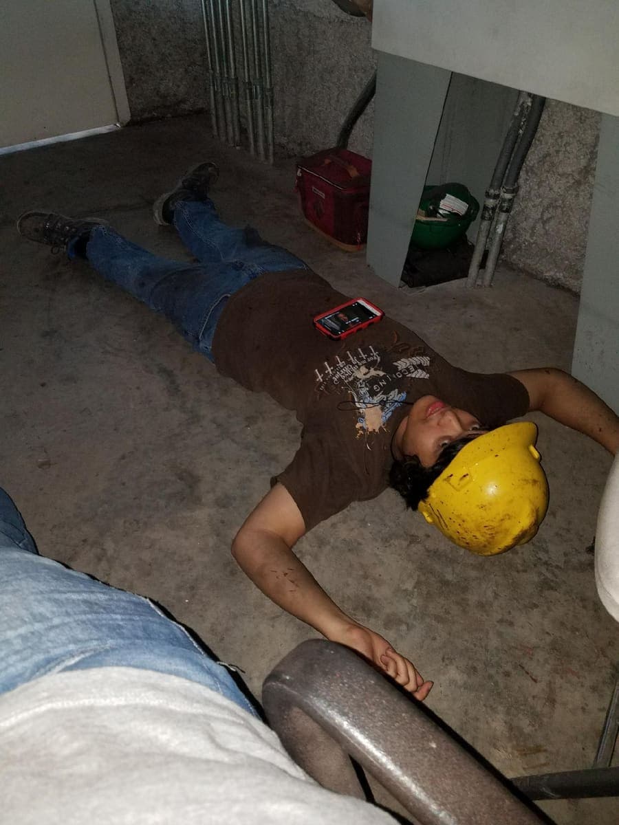 Taking a break on the concrete factory floor after a long shift