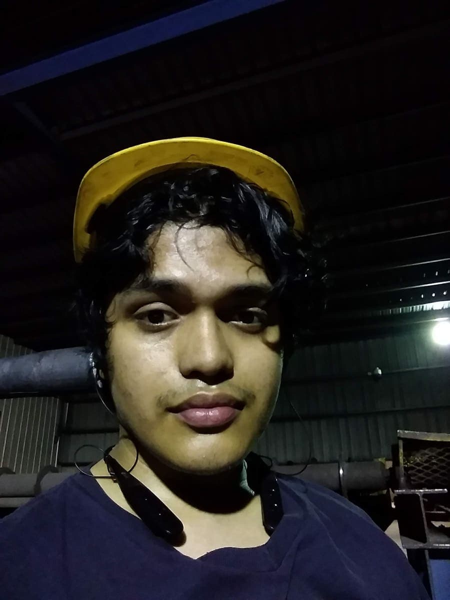 Agustin on the factory floor at Tubular Services wearing a yellow hard hat