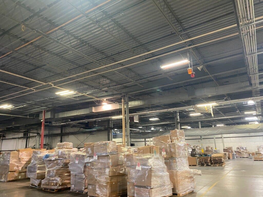 Shrink-wrapped pallets stacked on the BIDFTA warehouse floor