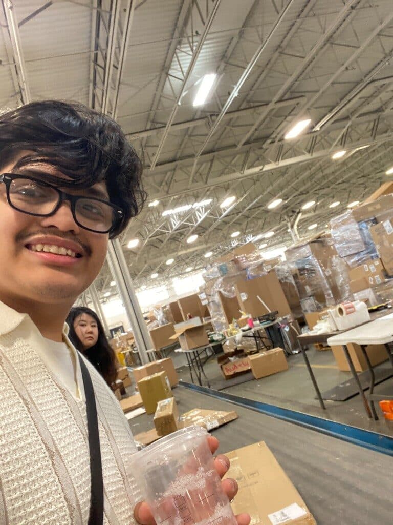 On the BIDFTA warehouse floor among pallets, boxes, and packing stations